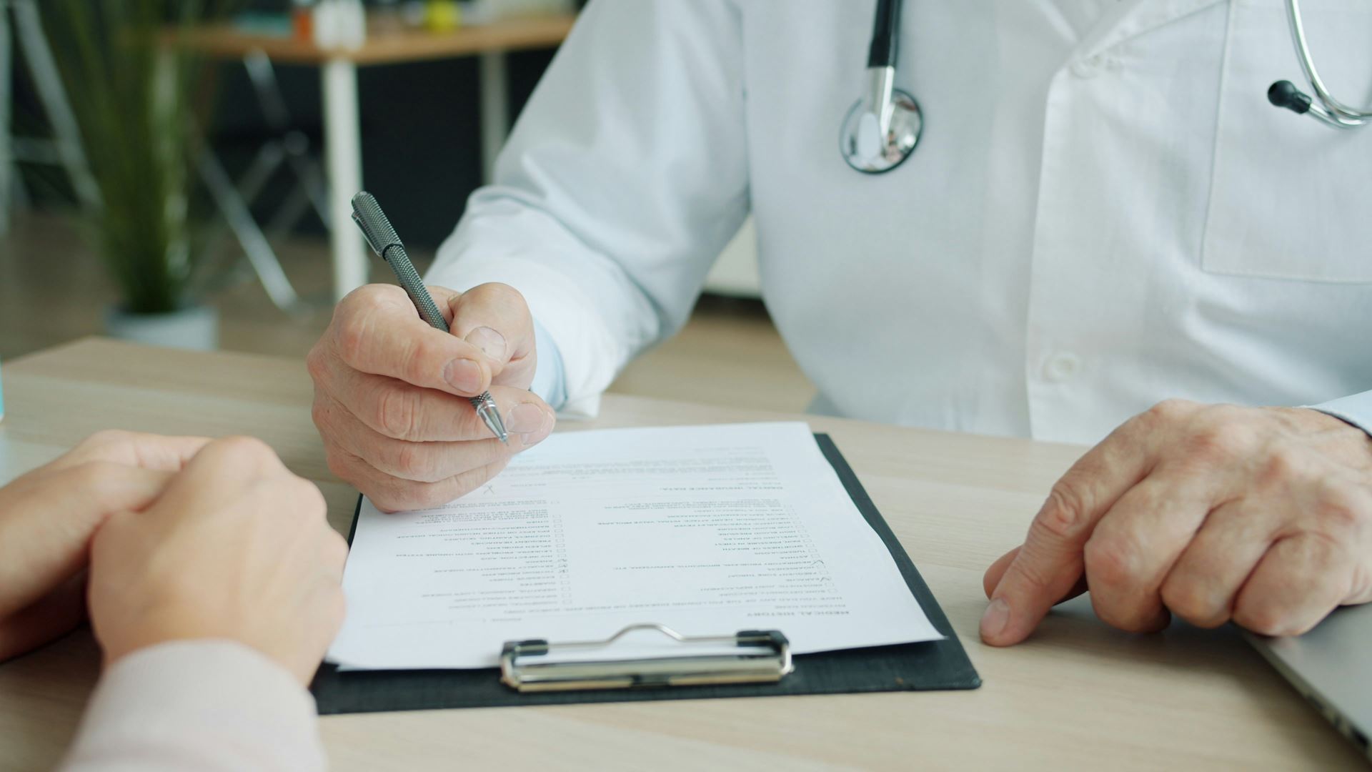 Doctor writing on notepad