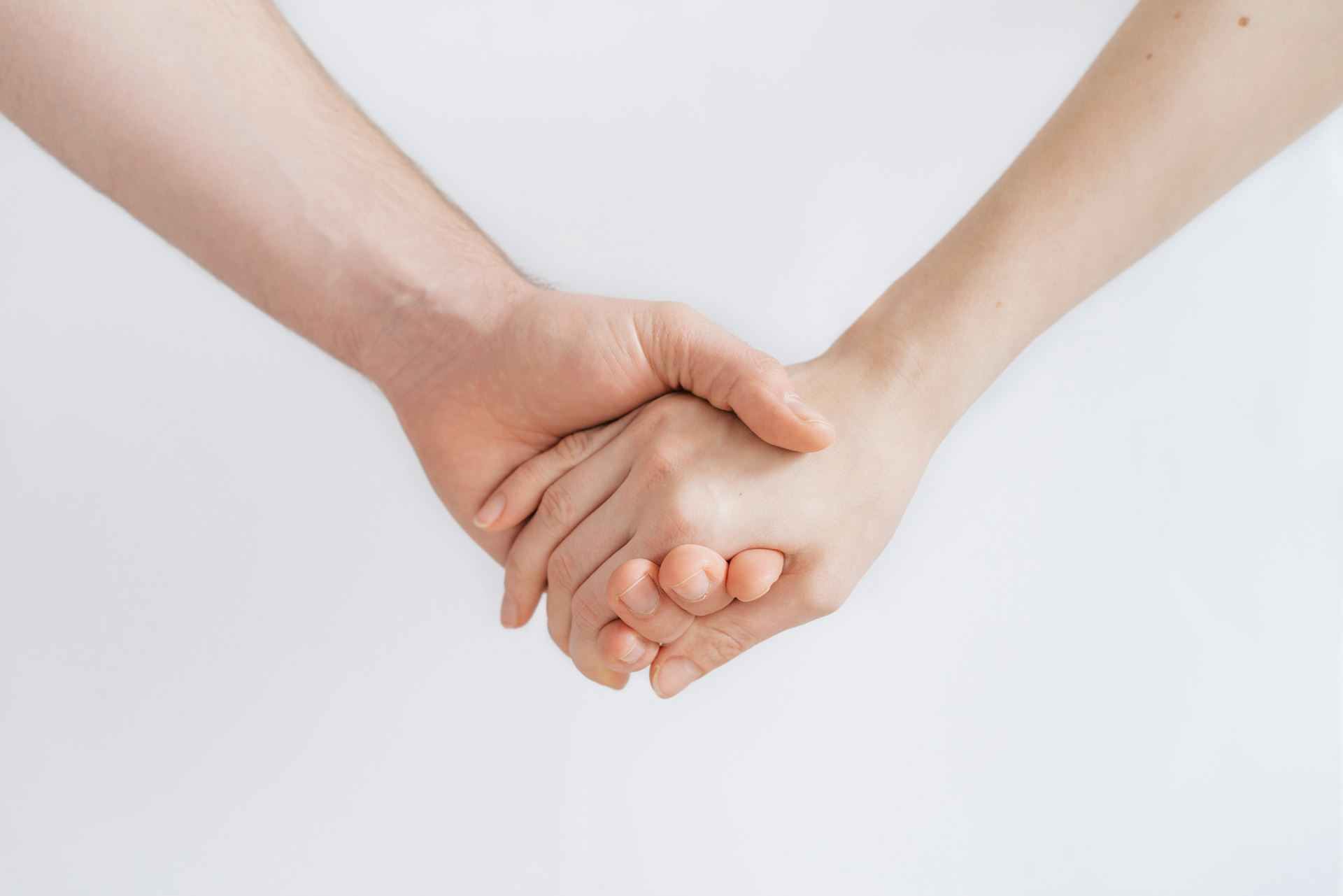 image of 2 people holding hands